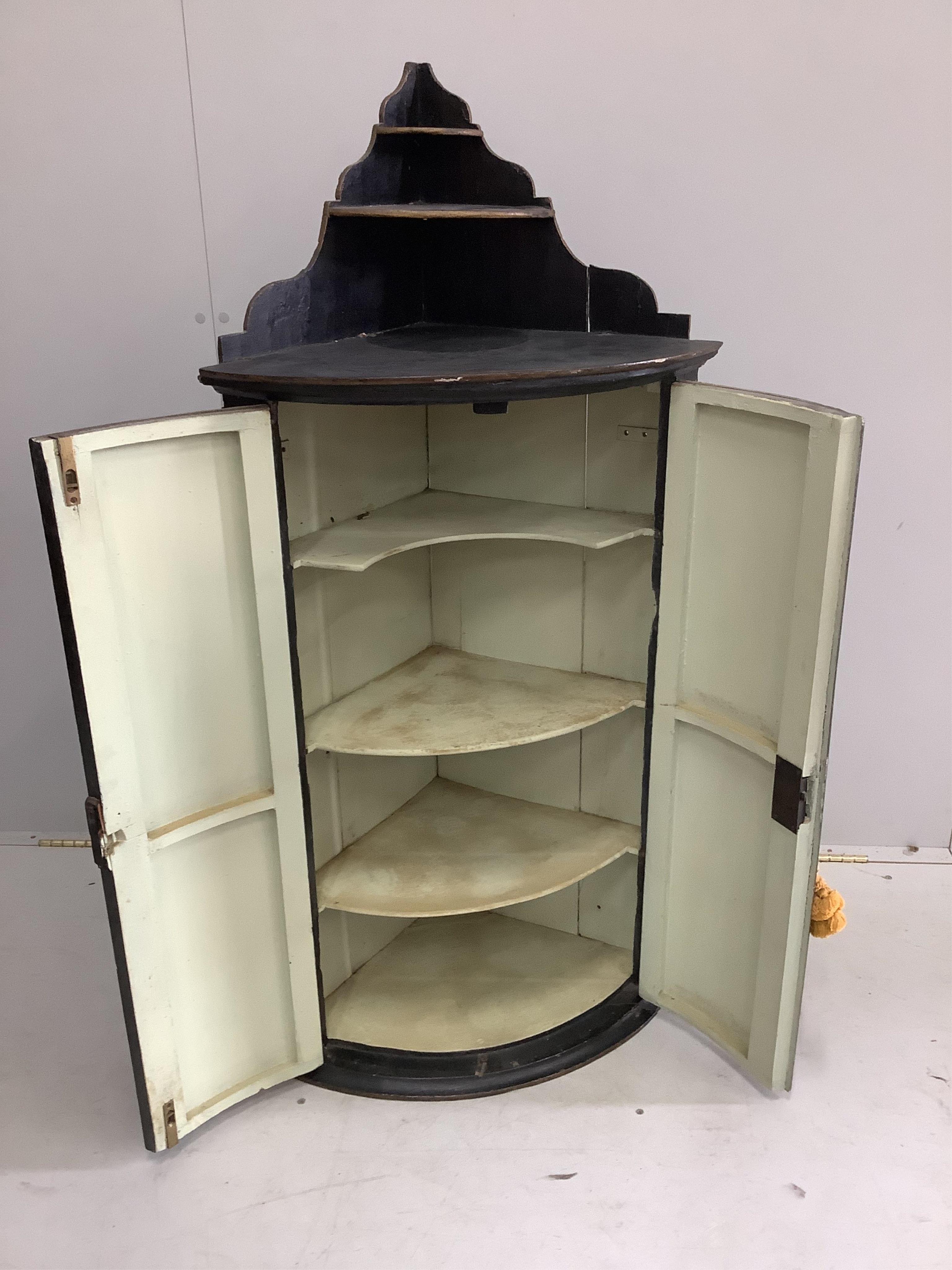 An 18th century chinoiserie lacquer bowfront hanging corner cupboard, width 59cm, depth 40cm, height 123cm. Condition - fair